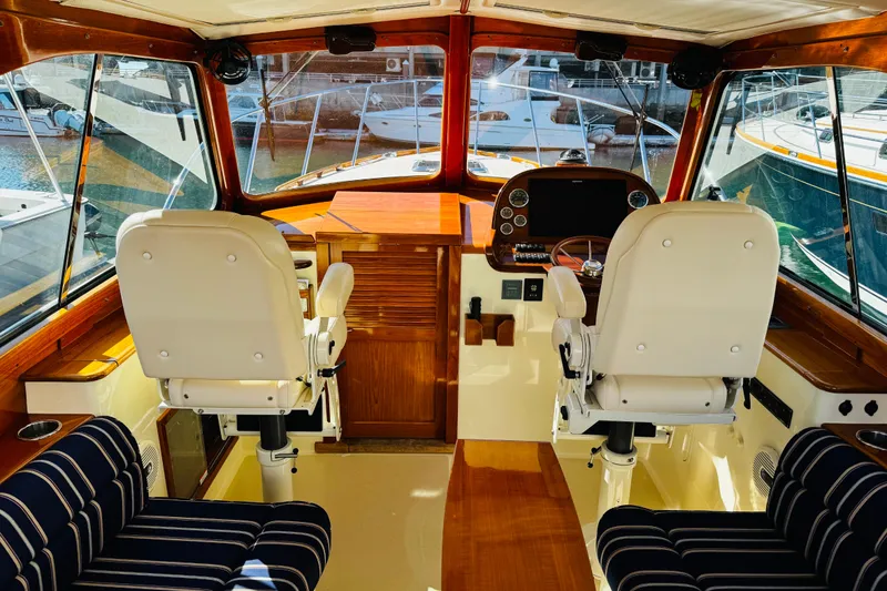 Slide: The Image of Interior of 2012 Hinckley Picnic Boat MKIII with helm and seating area. - 26