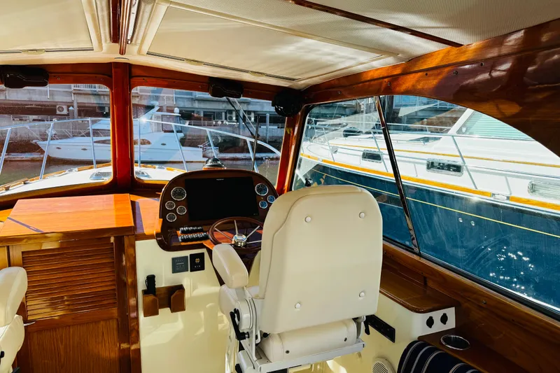 Slide: The Image of Interior view of 2012 Hinckley Picnic Boat MKIII helm with wooden accents and steering wheel. - 28