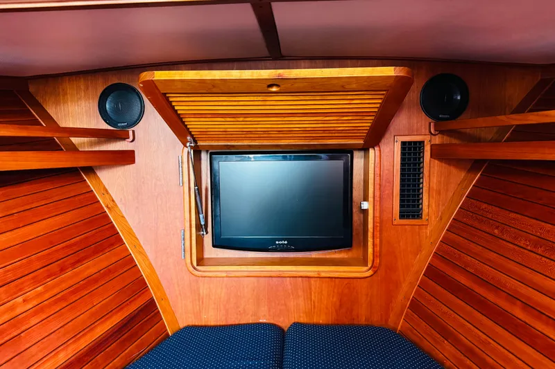 Slide: The Image of Interior of 2012 Hinckley Picnic Boat MKIII with wooden paneling and built-in TV. - 3