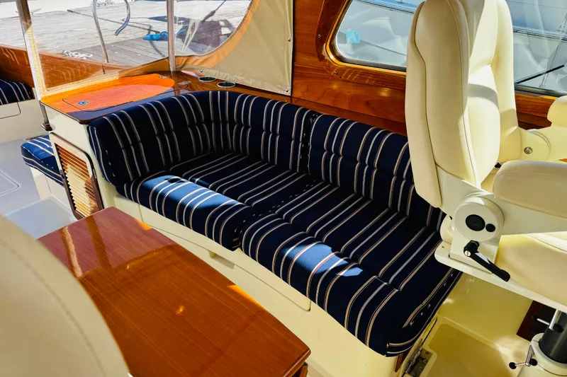 Slide: The Image of Luxurious interior of 2012 Hinckley Picnic Boat MKIII with striped seating and wooden accents. - 36