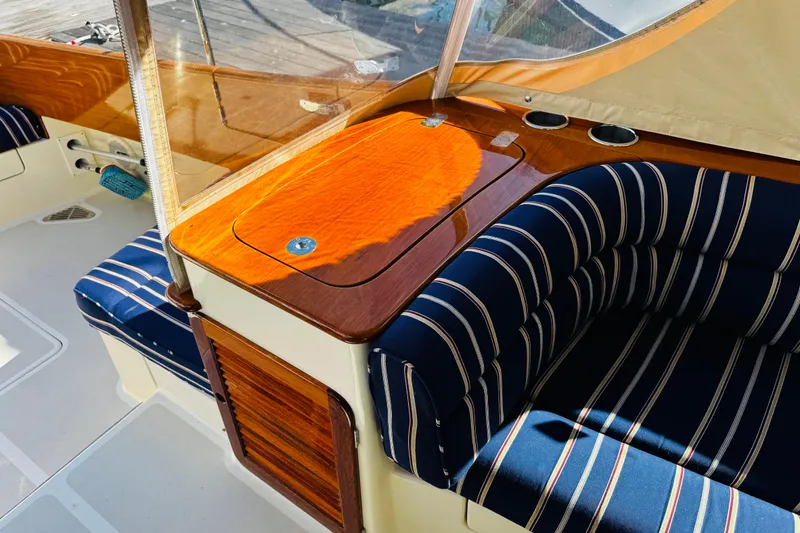 Slide: The Image of Interior of 2012 Hinckley Picnic Boat MKIII with striped seating and wooden accents. - 37