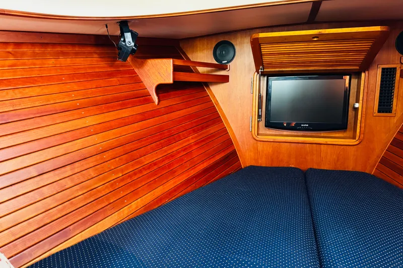 Slide: The Image of Interior of 2012 Hinckley Picnic Boat MKIII with wood paneling and TV. - 4