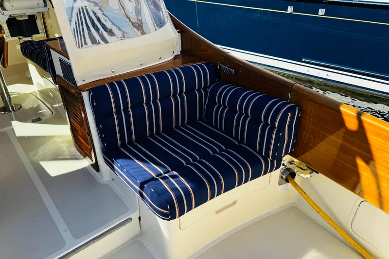 Slide: The Image of 2012 Hinckley Picnic Boat MKIII with striped seating and wooden accents. - 41