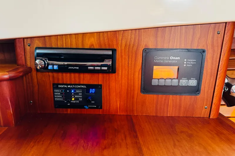 Slide: The Image of Hinckley Picnic Boat MKIII 2012 dashboard with Alpine stereo and Cummins Onan marine generator controls. - 44