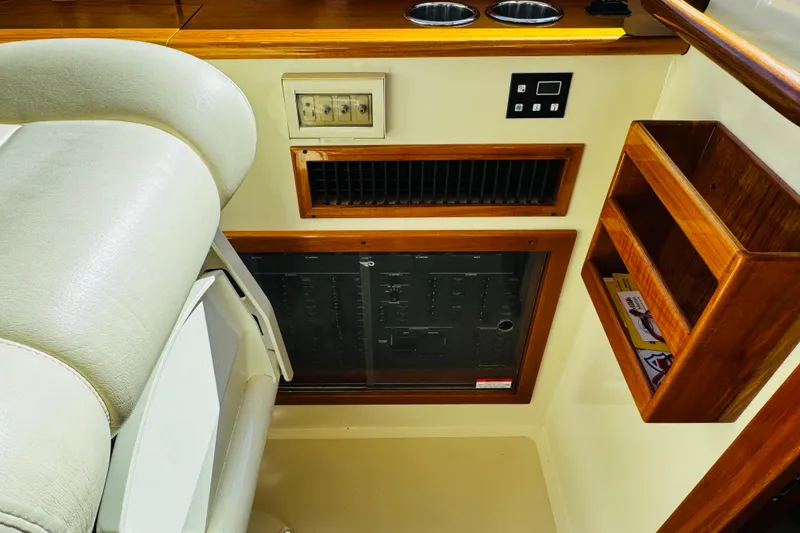 Slide: The Image of Interior of 2012 Hinckley Picnic Boat MKIII with control panel and wooden shelving. - 46