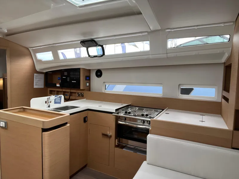 Slide: The Image of 2024 Jeanneau Sun Odyssey 410 interior kitchen with modern design and ample natural light. - 20