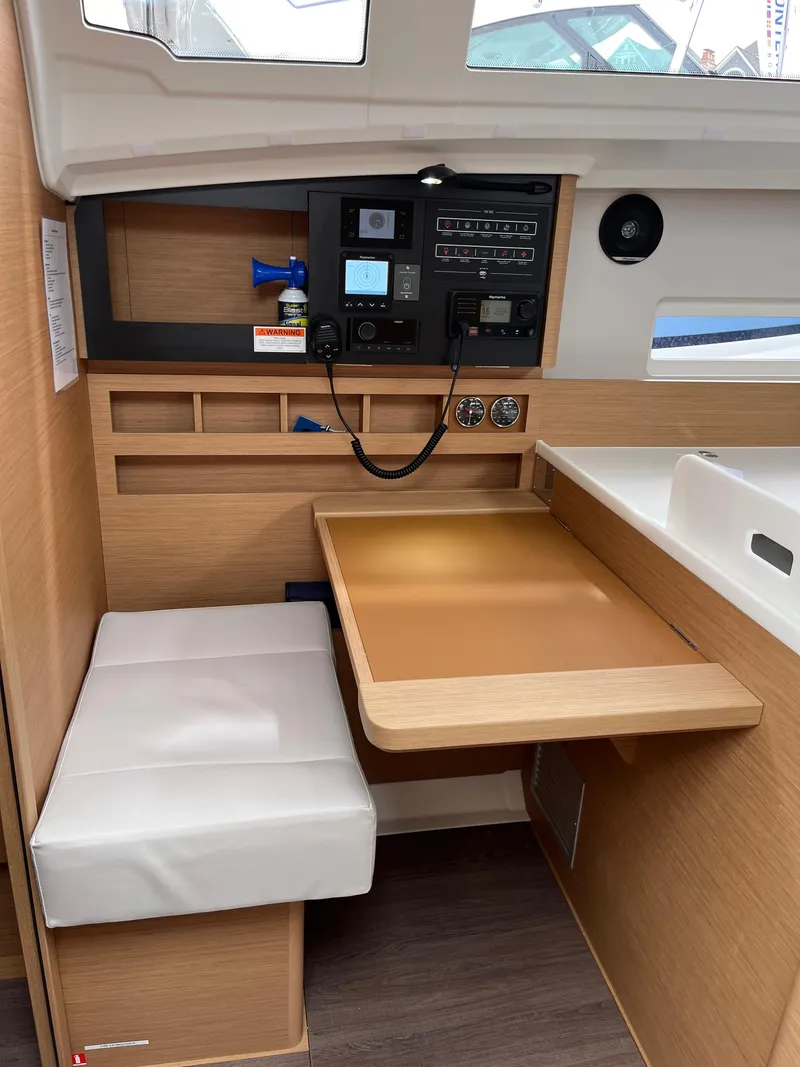 Slide: The Image of 2024 Jeanneau Sun Odyssey 410 interior with navigation station and seating. - 24