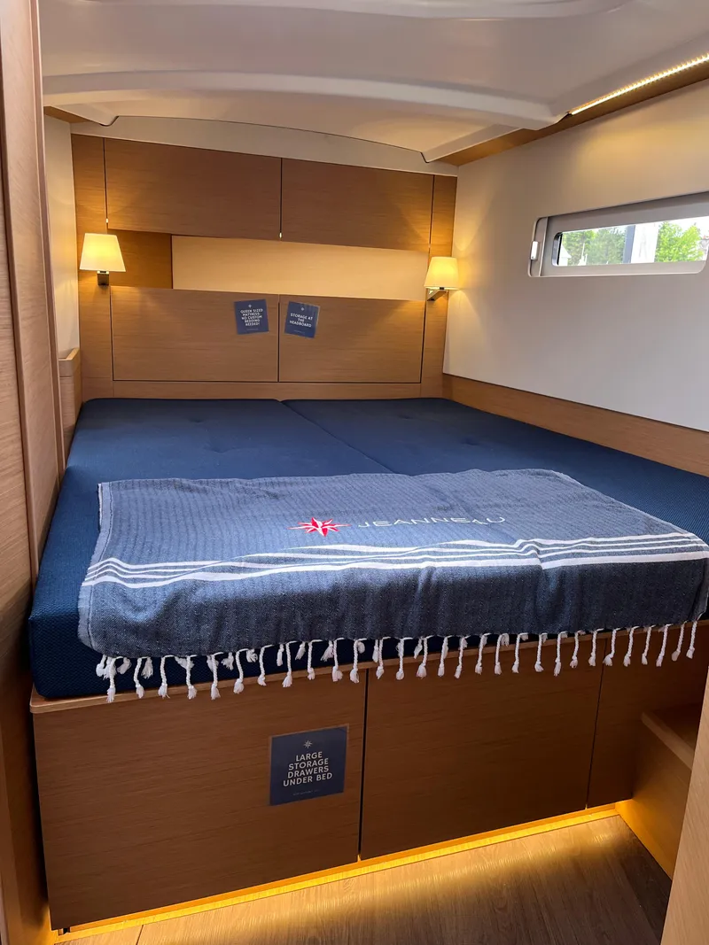 Slide: The Image of 2024 Jeanneau Sun Odyssey 410 cabin with cozy bed and ambient lighting. - 26