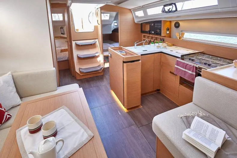 Slide: The Image of Interior of 2024 Jeanneau Sun Odyssey 410 yacht, featuring modern kitchen and cozy seating area. - 29