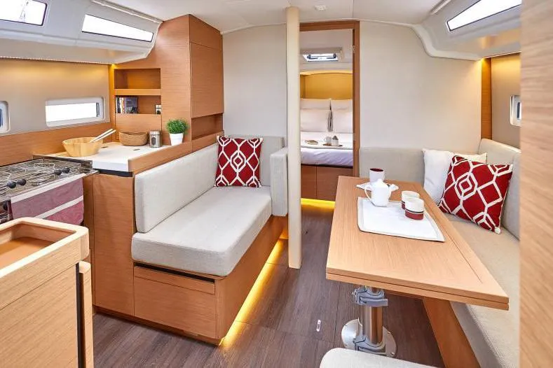 Slide: The Image of Interior of 2024 Jeanneau Sun Odyssey 410 yacht, featuring modern seating and dining area. - 32