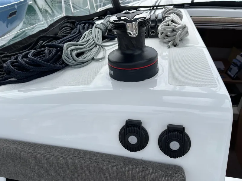 Slide: The Image of 2024 Jeanneau Sun Odyssey 410 deck with winch and neatly coiled ropes. - 7