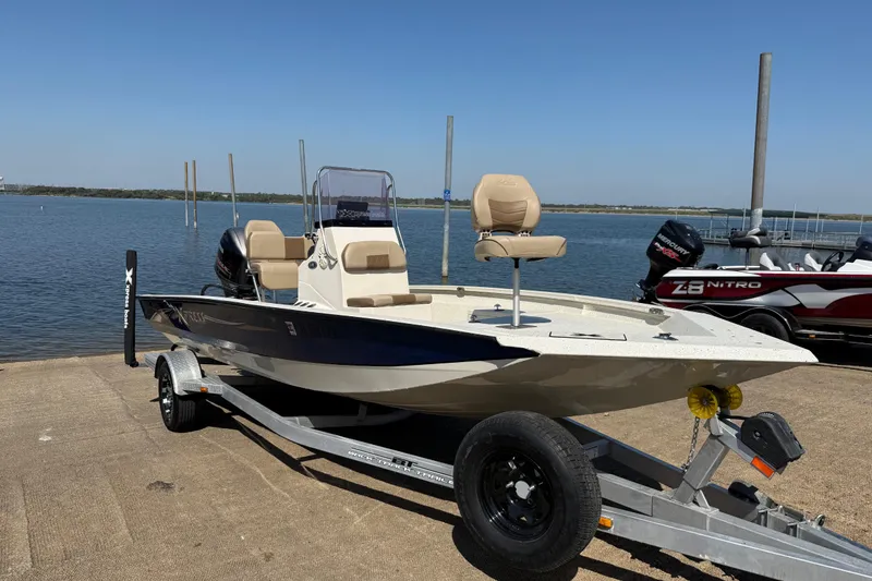Slide: The Image of 2018 Xpress H20B Bay boat on trailer by the water, ready for launch. - 26