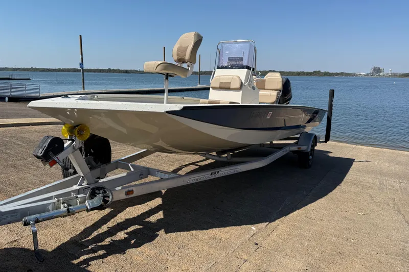 Slide: The Image of 2018 Xpress H20B Bay boat on trailer by the water. - 27