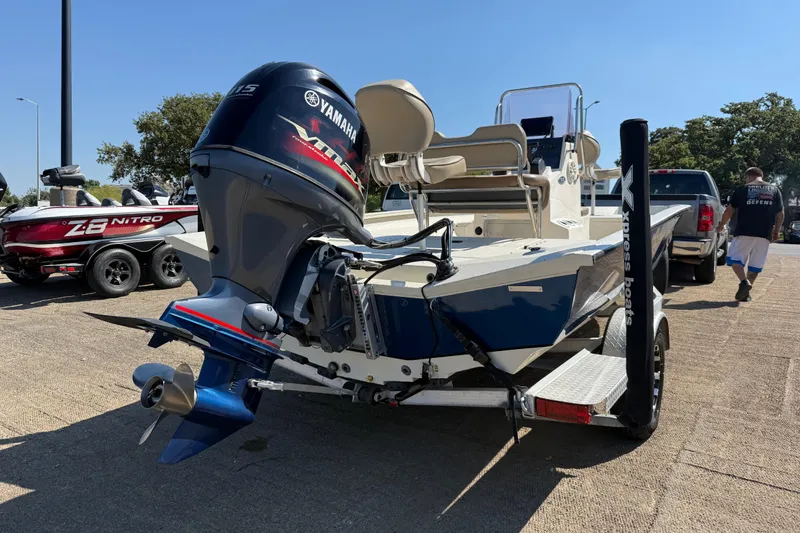Slide: The Image of 2018 Xpress H20B Bay boat with Yamaha engine on trailer, parked outdoors. - 42