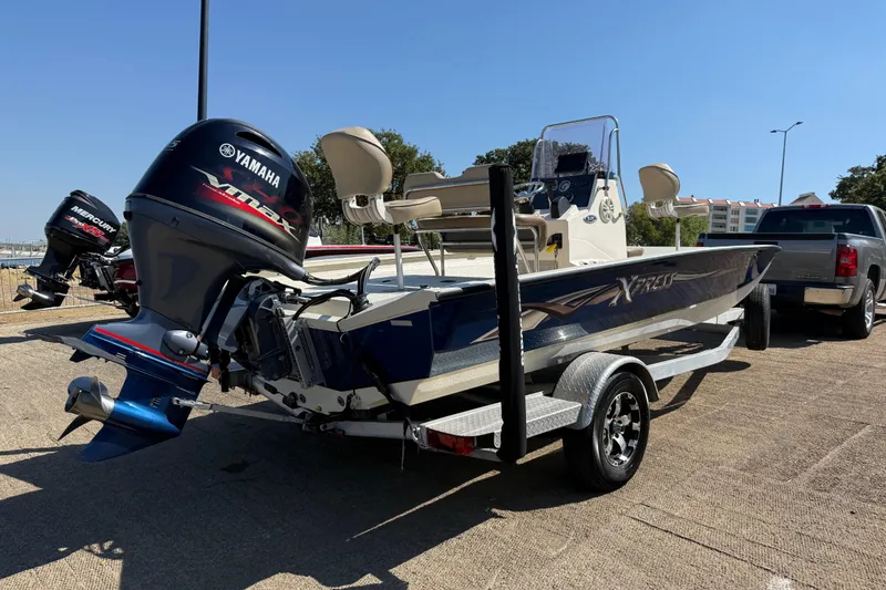 Slide: The Image of 2018 Xpress H20B Bay boat with Yamaha engine on trailer, parked outdoors. - 43