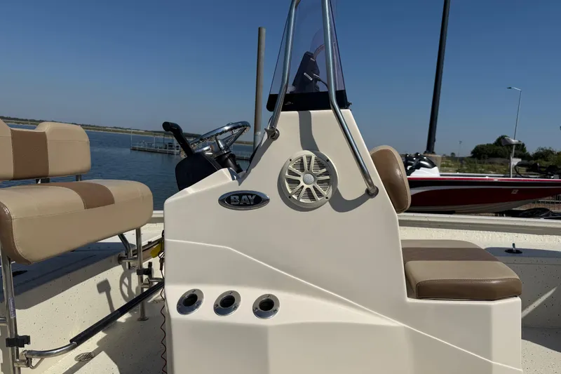 Slide: The Image of 2018 Xpress H20B Bay boat interior with beige seating and steering console. - 45