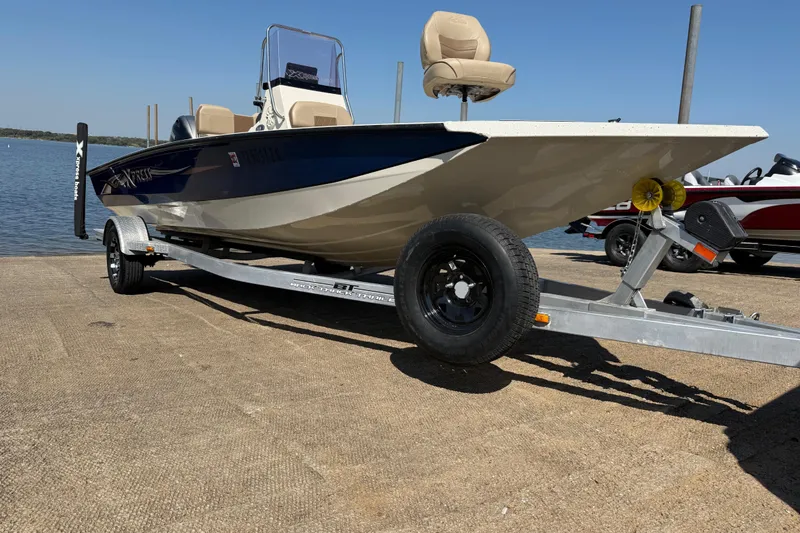 Slide: The Image of 2018 Xpress H20B Bay boat on trailer by the water. - 48