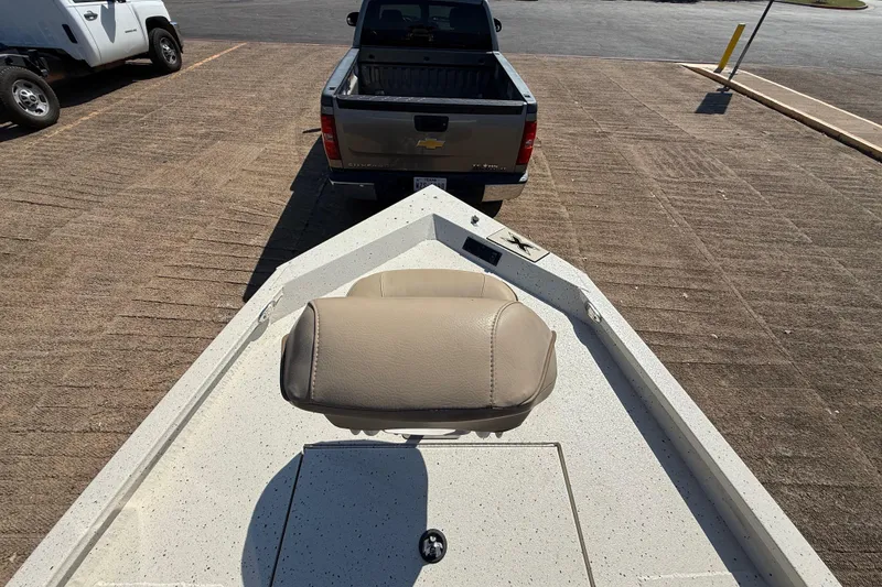 Slide: The Image of 2018 Xpress H20B Bay boat on trailer, parked behind a pickup truck. - 52