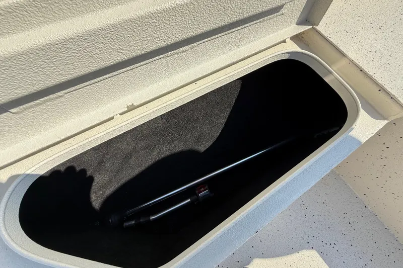 Slide: The Image of Storage compartment of 2018 Xpress H20B Bay boat, featuring a hydraulic lift. - 54