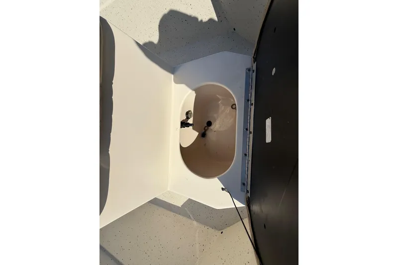Slide: The Image of 2018 Xpress H20B Bay boat storage compartment, open lid, interior view. - 56