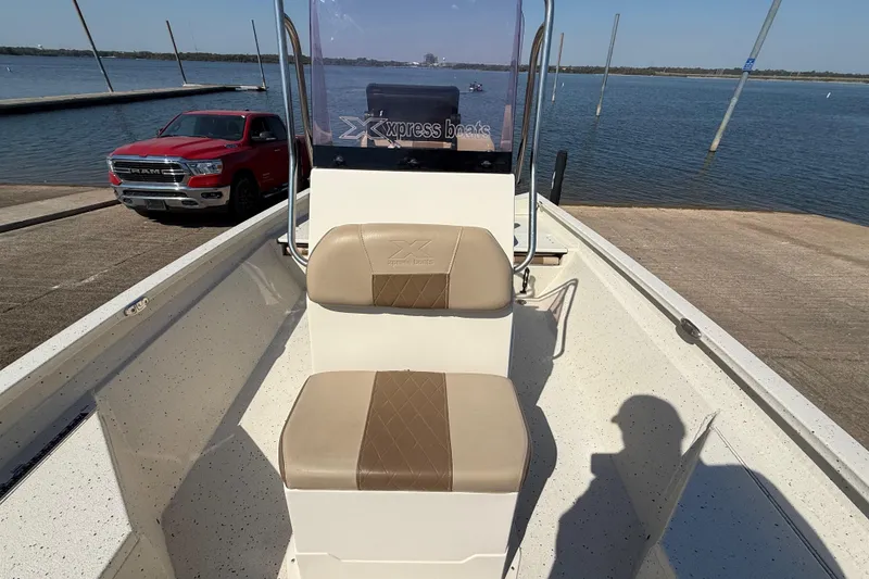 Slide: The Image of 2018 Xpress H20B Bay boat at dock with red truck nearby. - 57