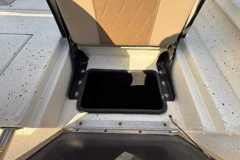 Slide: The Image of Open storage compartment on 2018 Xpress H20B Bay boat with beige seat. - 60