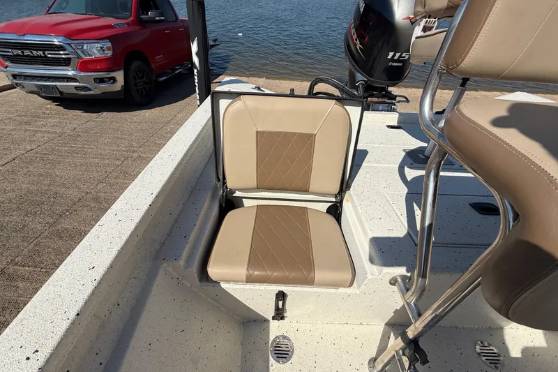 Slide: The Image of 2018 Xpress H20B Bay boat interior with tan seating and Yamaha 115 engine. - 61