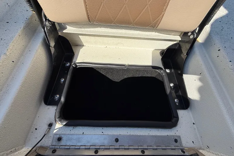 Slide: The Image of 2018 Xpress H20B Bay boat storage compartment with open lid and cushioned seat. - 62