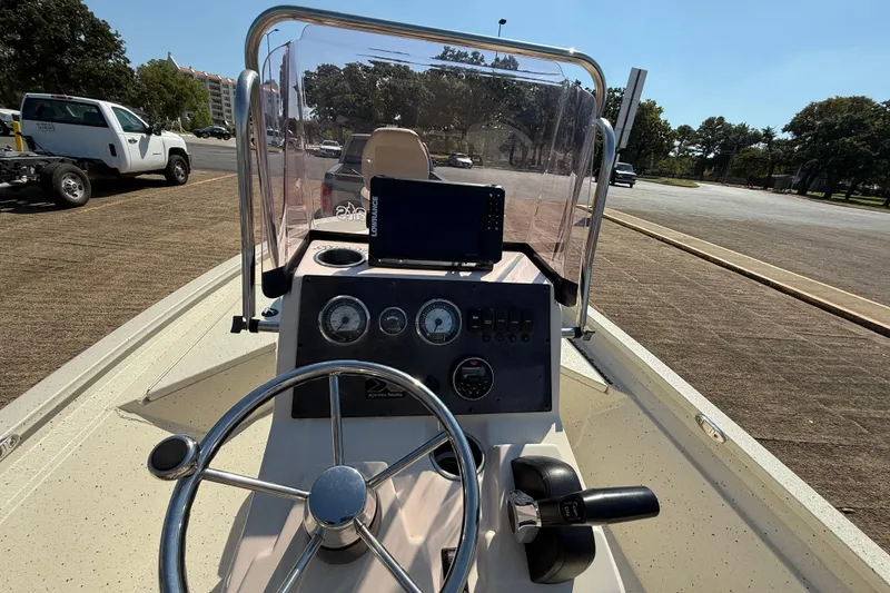 Slide: The Image of 2018 Xpress H20B Bay boat dashboard with steering wheel and navigation system. - 63