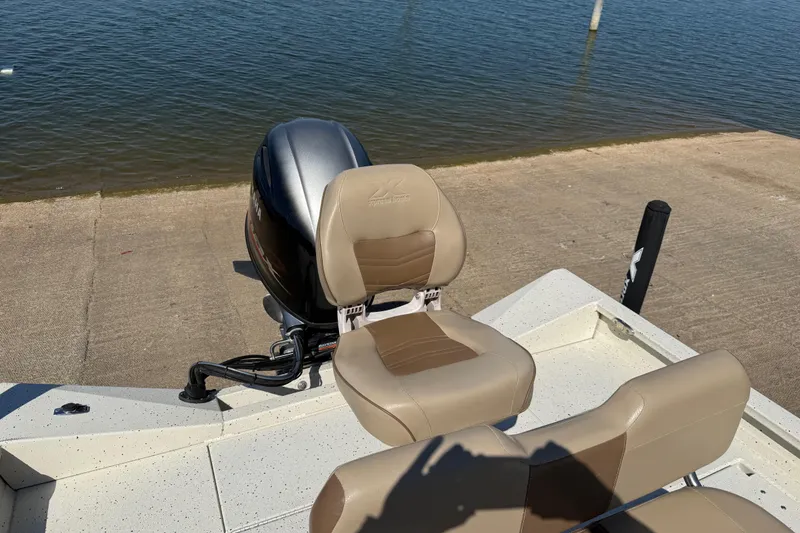 Slide: The Image of 2018 Xpress H20B Bay boat with Yamaha outboard motor and beige seating by the water. - 68