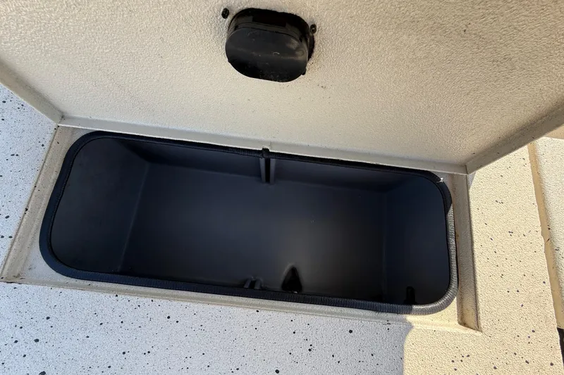 Slide: The Image of Open storage compartment on 2018 Xpress H20B Bay boat, showing interior space. - 69