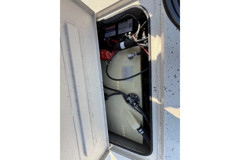 Slide: The Image of 2018 Xpress H20B Bay boat battery compartment with wiring and components. - 70