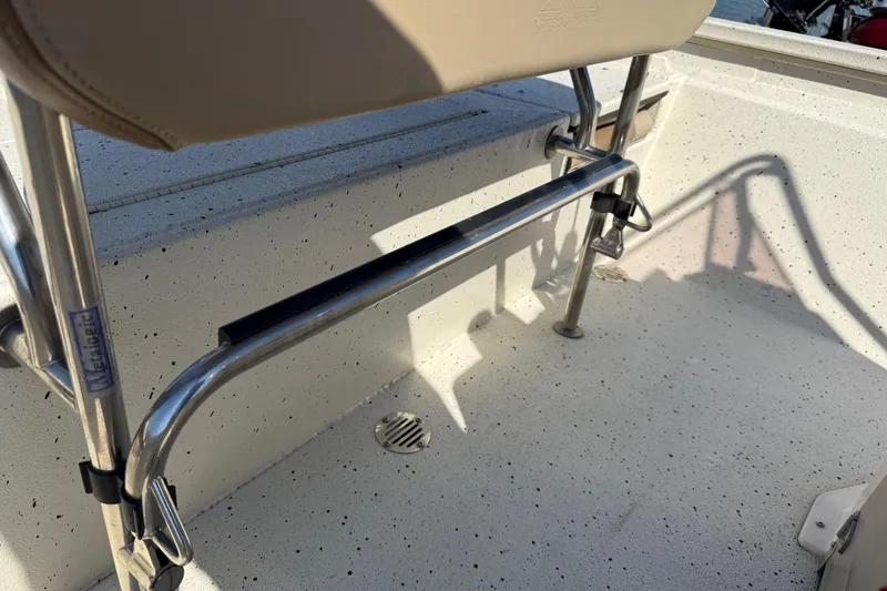 Slide: The Image of 2018 Xpress H20B Bay boat interior with stainless steel fittings and beige seating. - 72