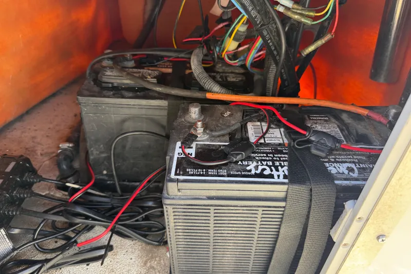 Slide: The Image of 2018 Xpress H20B Bay boat battery compartment with wiring and connections. - 75