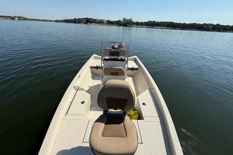 Slide: The Image of 2018 Xpress H20B Bay boat on calm water, featuring comfortable seating and open deck. - 76