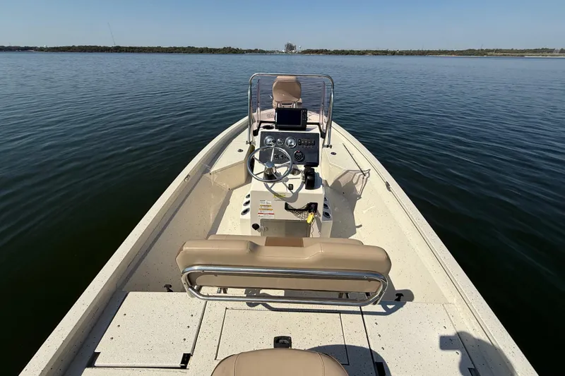 Slide: The Image of 2018 Xpress H20B Bay boat on calm water, featuring a sleek console and seating. - 78