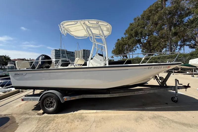 Slide: The Image of 2019 Boston Whaler 190 Montauk boat docked at marina, sunny day. - 0