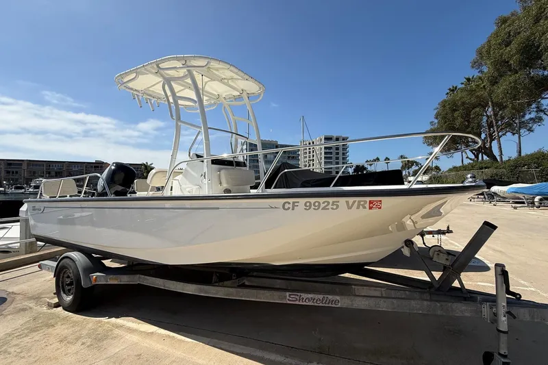 Slide: The Image of 2019 Boston Whaler 190 Montauk boat docked at marina with clear blue sky. - 1
