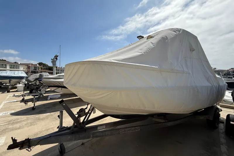 Slide: The Image of 2019 Boston Whaler 190 Montauk boat on trailer at marina, sunny day. - 13