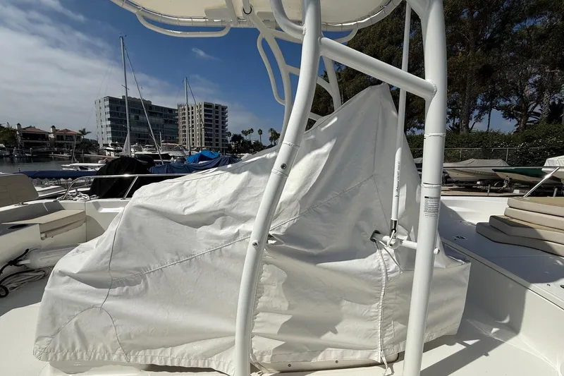 Slide: The Image of 2019 Boston Whaler 190 Montauk boat docked at marina under clear blue sky. - 14