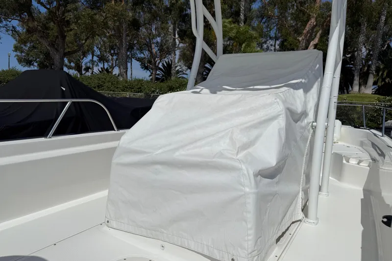 Slide: The Image of Boston Whaler 190 Montauk 2019 boat canopy with rod holders against blue sky. - 15