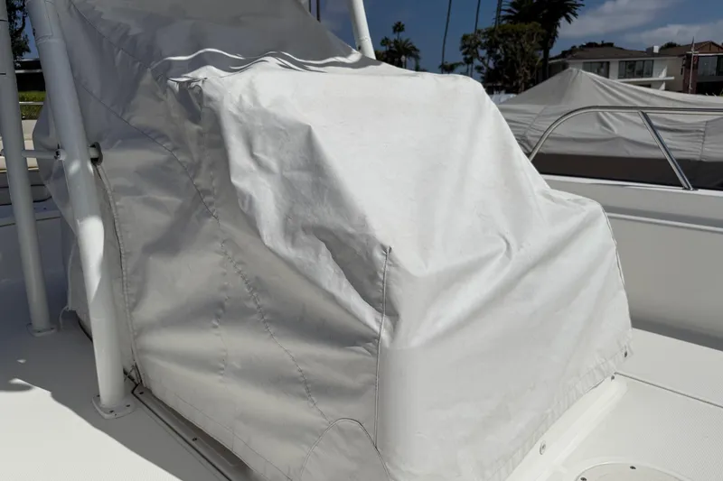 Slide: The Image of Covered 2019 Boston Whaler 190 Montauk on trailer at marina, under cloudy sky. - 17