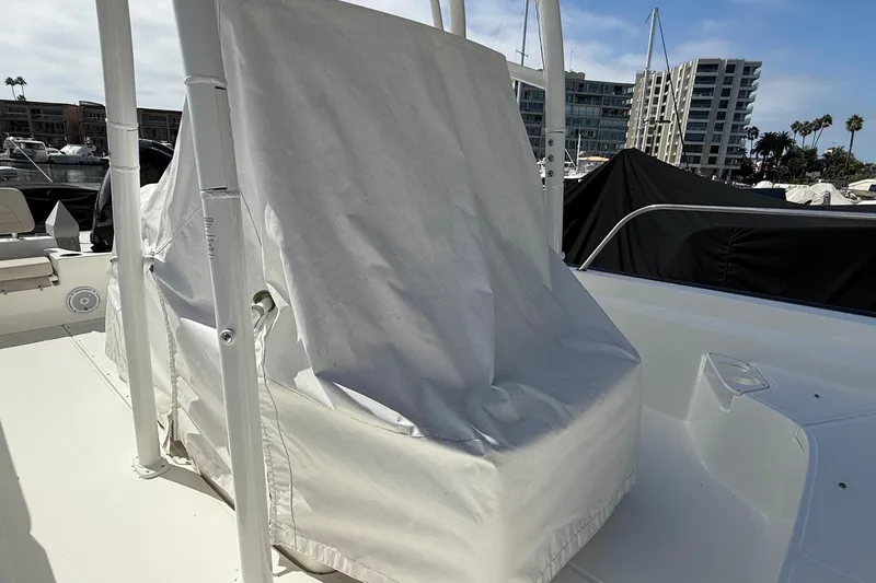 Slide: The Image of Covered 2019 Boston Whaler 190 Montauk boat on trailer under clear sky. - 19