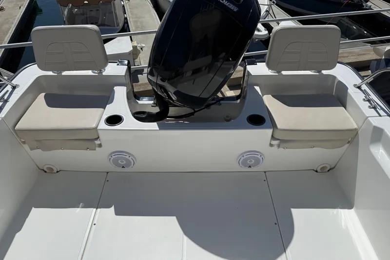 Slide: The Image of 2019 Boston Whaler 190 Montauk boat with cover, docked in marina. - 20
