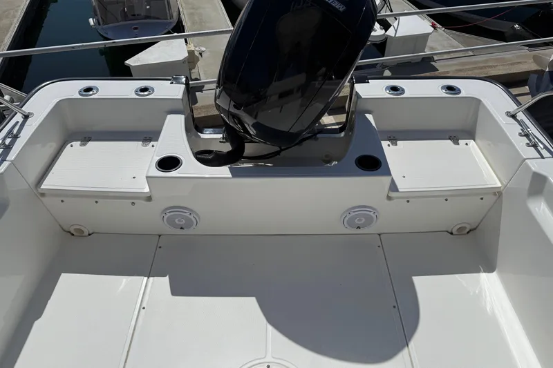 Slide: The Image of 2019 Boston Whaler 190 Montauk boat with covered console, surrounded by trees. - 21