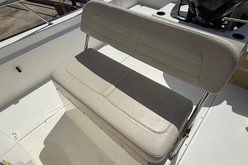Slide: The Image of 2019 Boston Whaler 190 Montauk boat with covered console, docked outdoors. - 23