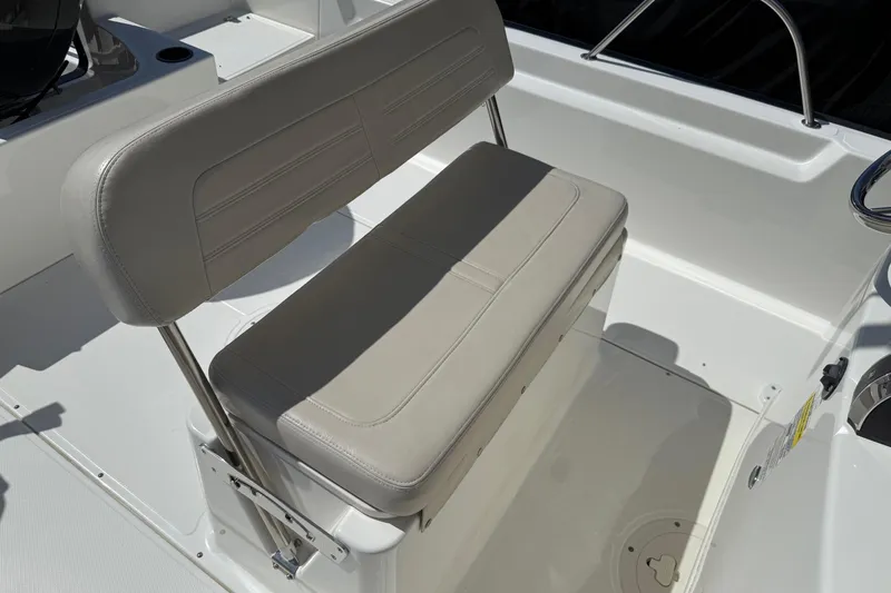 Slide: The Image of 2019 Boston Whaler 190 Montauk boat with covered seating, docked in a marina. - 24