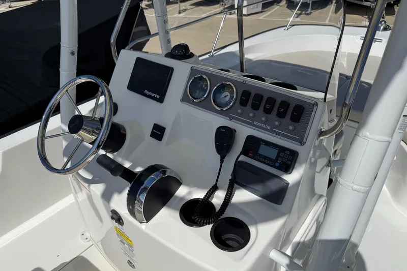 Slide: The Image of 2019 Boston Whaler 190 Montauk boat interior with seating and motor. - 26