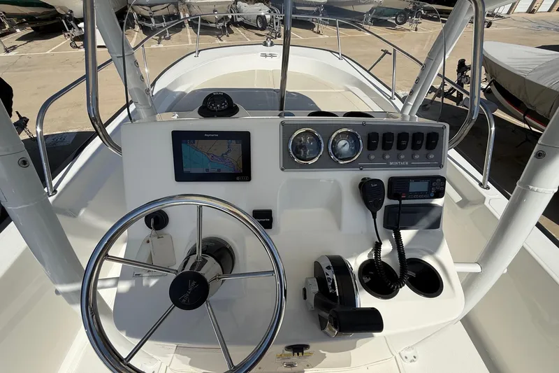 Slide: The Image of 2019 Boston Whaler 190 Montauk boat interior with motor and storage compartments. - 27