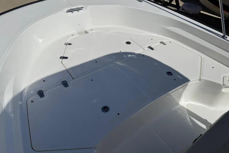 Slide: The Image of 2019 Boston Whaler 190 Montauk boat deck with storage compartments and clean white finish. - 37